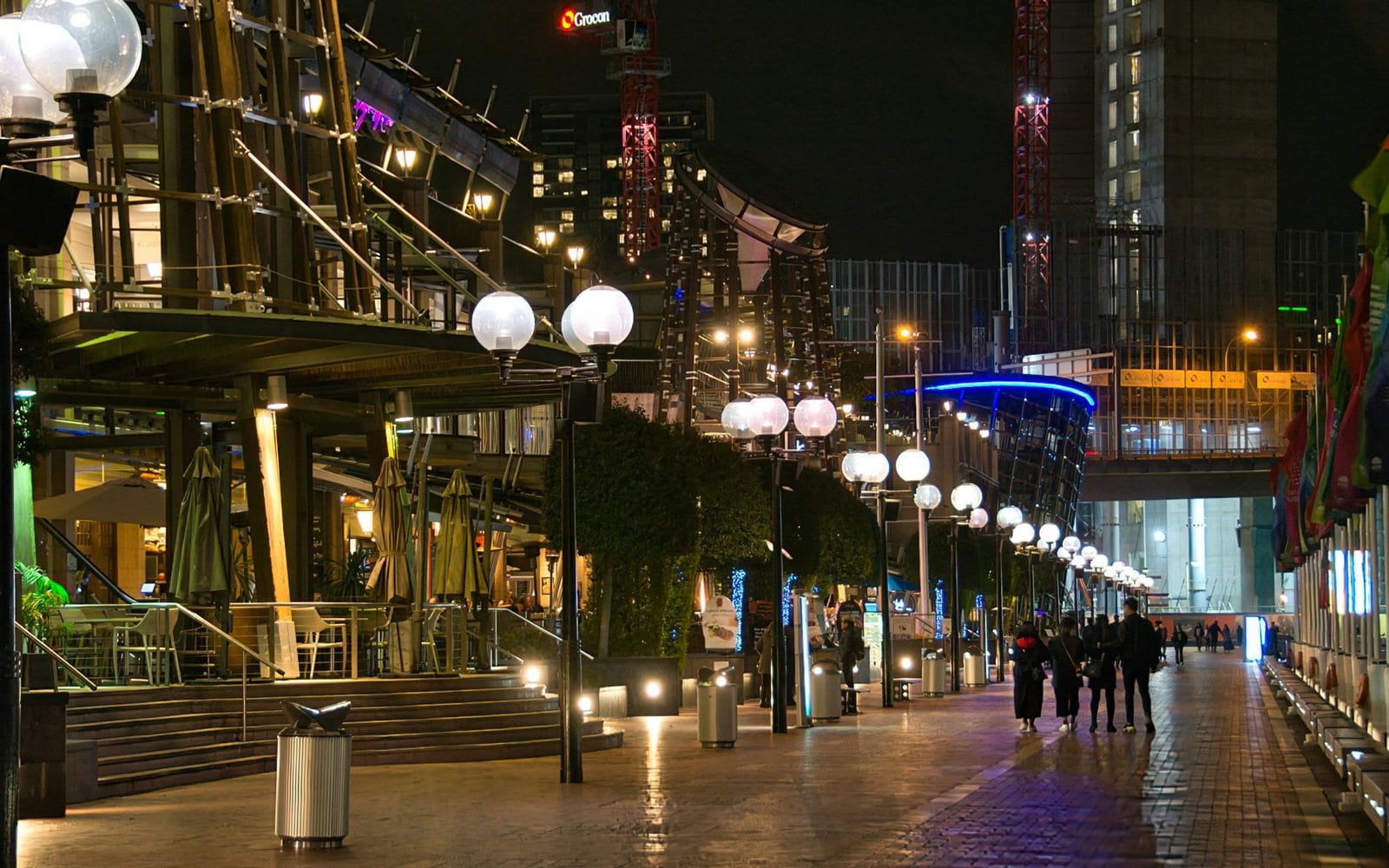 A row of restaurants lit up at Darling Harbour, a few minutes' walk from Pyrmont and from the convention centre that sets the suburb's calendar.